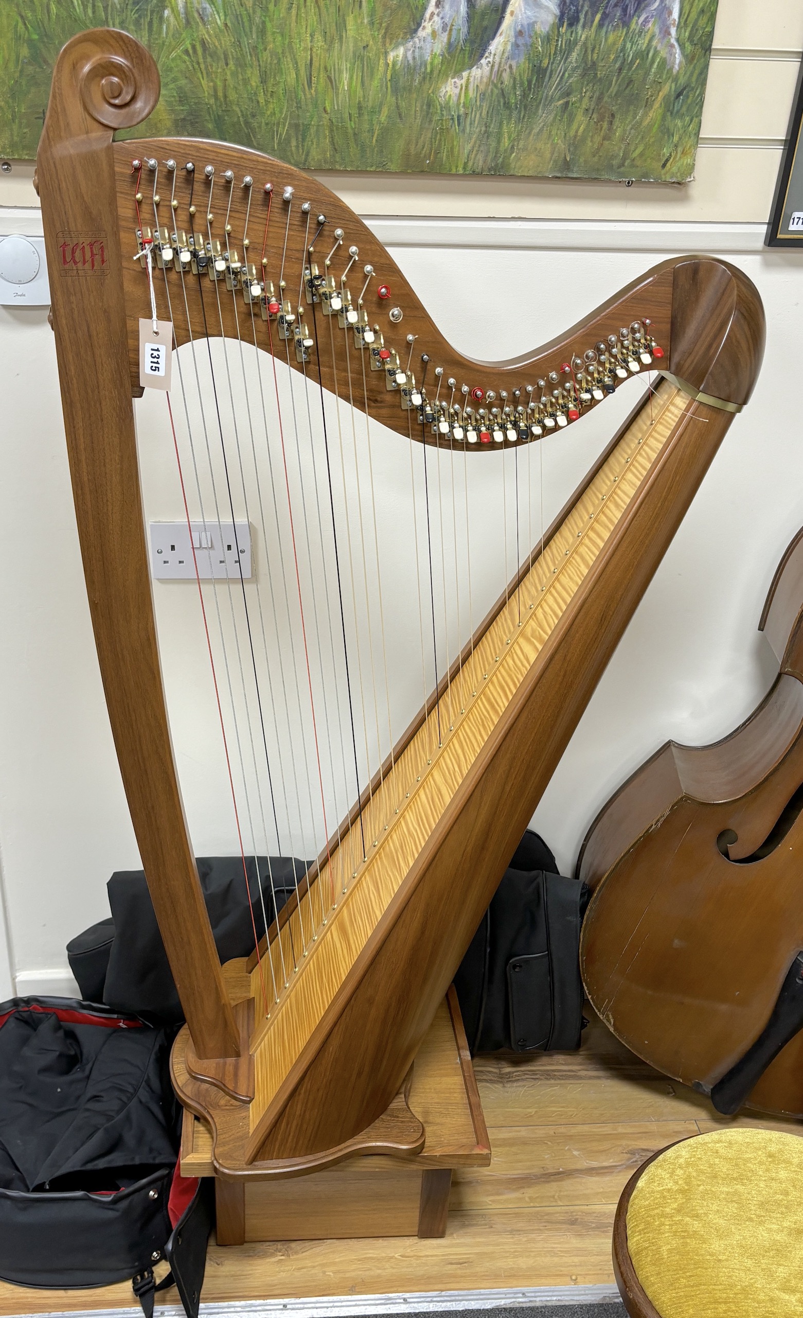 A modern Welsh Teifi Telynau harp, 36 string harp with maple sound board, carved maker’s mark, stool, stand and tuner, with substantial padded cover and transport case, 130cm high